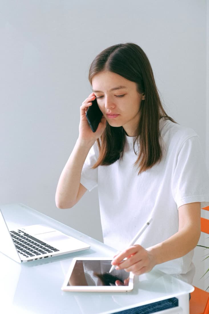 A person reviewing figures on a laptop during a video call